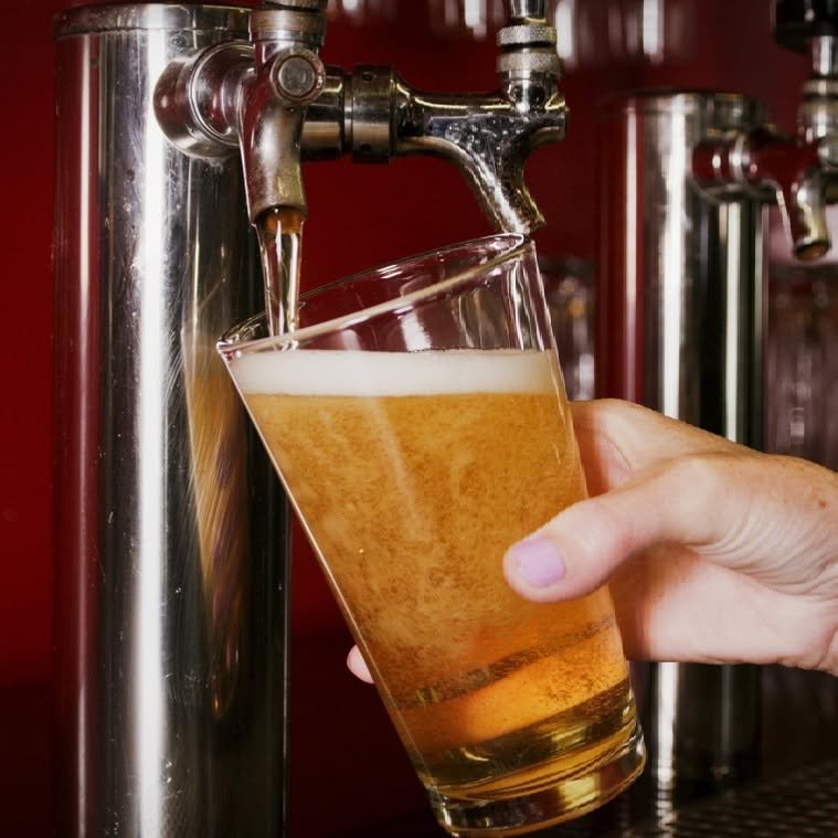 A cold beer being poured from the tap at Turn 12's bar