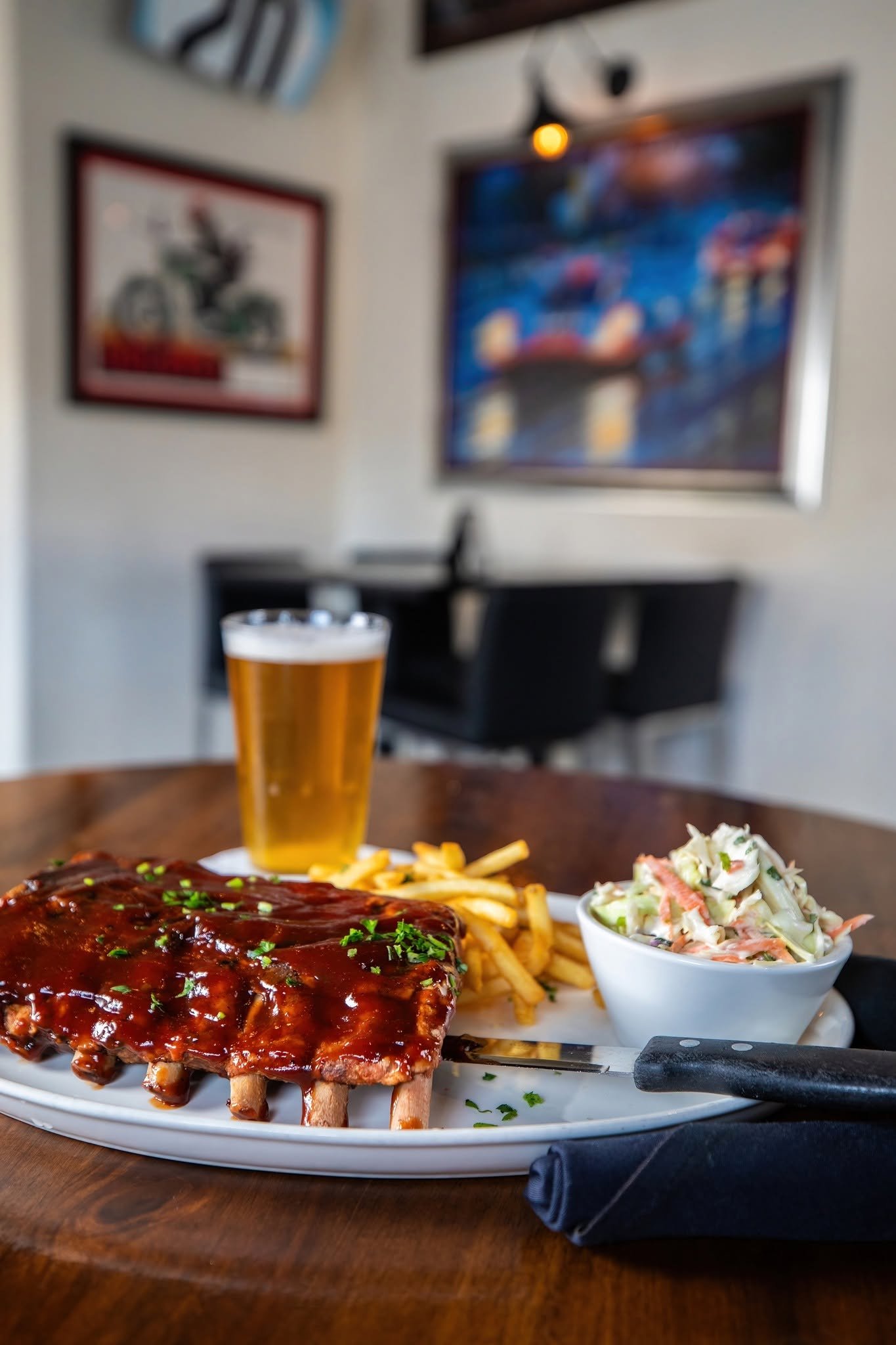 Slow-cooked baby back ribs with fries and coleslaw